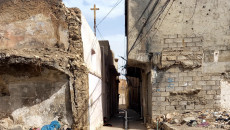 Sole Christian of Mosul neighborhood raises cross over house