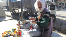 Abu Omar weaves rosaries with old beads