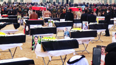 Ezidis buy coffins and transport remains of relatives slaughtered by ISIS