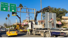 Who removed Kurdish from signs in Kirkuk?