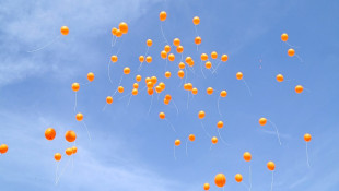 Orange balloons by women activists cover the sky of Kirkuk