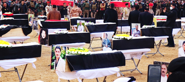 Ezidis buy coffins and transport remains of relatives slaughtered by ISIS