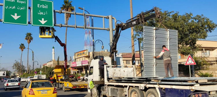Who removed Kurdish from signs in Kirkuk?